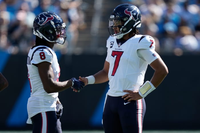 Houston Texans wide receiver John Metchie III (8) shakes hands with quarterback C.J. Stroud (7) during a time out to check for a touchdown run during the second quarter against the Carolina Panthers at Bank of America Stadium.